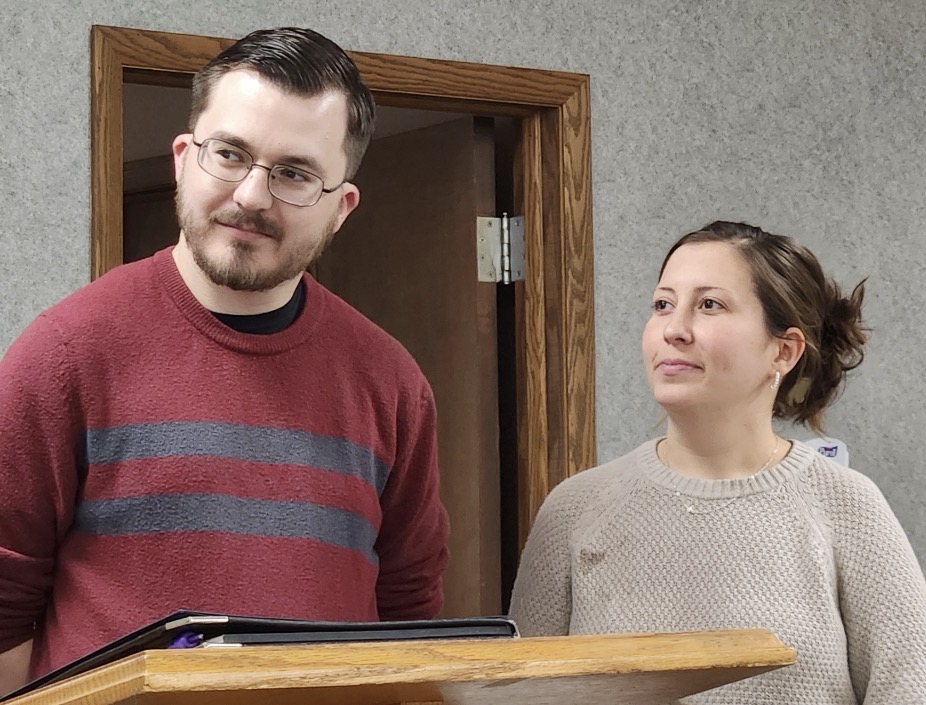Pastor Noah Raines and another member of New Life Fellowship standing together at the podium